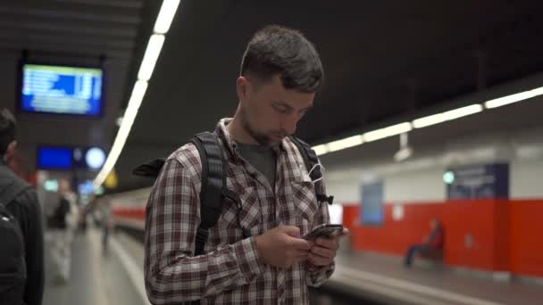 Young Man Waiting His Train Checking Schedule Railway Traffic While — Stockvideo