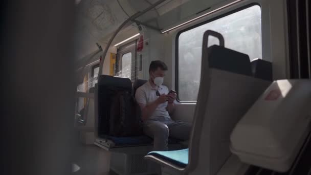 Passenger Travelling Train Wearing Mask Using His Phone Browse Internet — Vídeo de stock