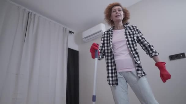 Cheerful Mature Female Cleaning New Apartment Furniture Mopping Floor Mop — Wideo stockowe