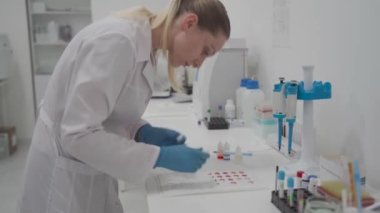 Red blood cell compatibility table. Donation. Donor and recipient. Lab technician does blood test to determine blood type, Rh factor, and compatibility. Blood drops with different types. 