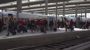 March 20, 2022. Munich. Germany. Deutsche Bahn ICE train stands on the Munich Hauptbahnhof platform and many passengers get off train and walk through the station. Munchen Hbf. Intercity-Express. 
