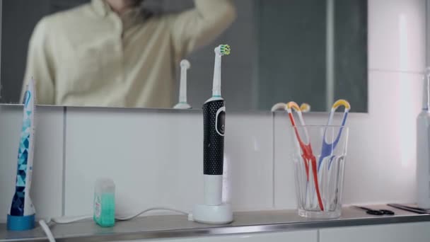 Man Removes Electric Toothbrush Charge Brushes Teeth Work Morning Male — Stok Video