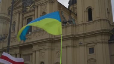 Munich. Germany. Odeonsplatz muenchen. Subject of war between Russia and Ukraine. Protesters holding yellow and blue and European Union flags at demonstration against war in Bayern. 