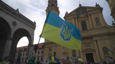 Munich. Germany. Odeonsplatz muenchen. Subject of war between Russia and Ukraine. Protesters holding yellow and blue and European Union flags at demonstration against war in Bayern. 
