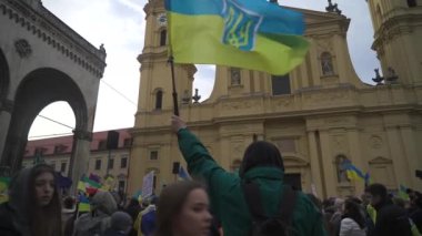 February 18, 2023. Munich. Germany. Odeonsplatz muenchen. Subject of war between Russia and Ukraine. Protesters holding yellow and blue and European Union flags at demonstration against war in Bayern