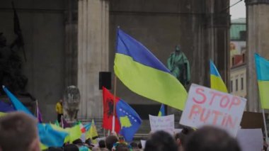 Munich. Germany. Odeonsplatz muenchen. Subject of war between Russia and Ukraine. Protesters holding yellow and blue and European Union flags at demonstration against war in Bayern. 
