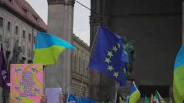 Munich. Germany. Odeonsplatz muenchen. Subject of war between Russia and Ukraine. Protesters holding yellow and blue and European Union flags at demonstration against war in Bayern. 