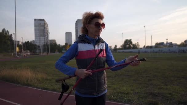 Elderly Woman Stacks Walking Sticks City Stadium Workout Mature Athletic — Stock Video