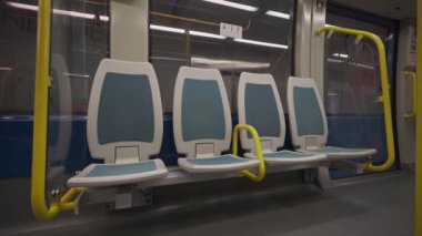 Porto Metro, Portekiz 'de boş bir tren. Menekşe hattında havaalanına giden kimse yok. Porto sarısı renkte bir metro vagonu. Metro toplu taşımacılığı boş koltuklu trenin iç görünümü