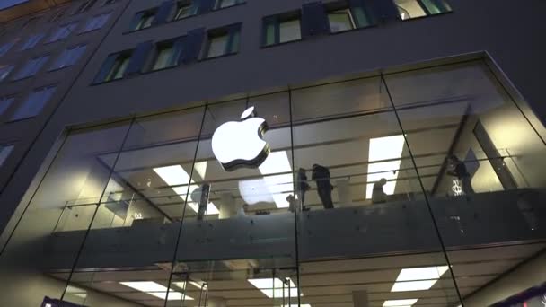 2022年11月18日 慕尼黑 外面是Marienplatz上苹果商店的晚间立面 苹果店面两层楼 顾客搬进来 夜晚点亮苹果标识 在德国购物 — 图库视频影像
