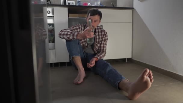 Drunk Sad Man Sitting Kitchen Floor Drinking Wine Bottle Drunken — Vídeo de stock