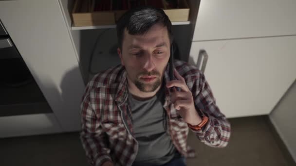Drunken Depressed Man Sitting Kitchen Floor Home Drinking Wine Bottle — Stock Video