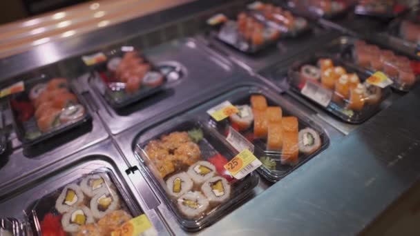 戴防护口罩的男人从超市货架上拿走寿司盒 新的规范 没有面具 没有入境 社会距离和检疫系数19 准备在午餐盒里吃的日本食品 — 图库视频影像