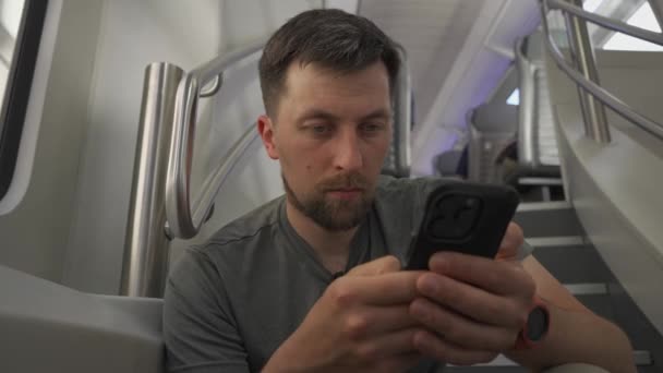 Genç Adam Çift Katlı Trenle Seyahat Ediyor Akıllı Telefonunu Kullanarak — Stok video