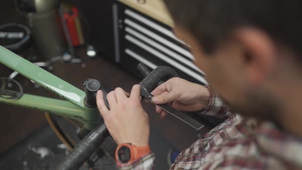 작업장에서 사이클의 핸들에 새로운 테이프를 자전거 자전거 서비스의 자전거 기술자 — 비디오