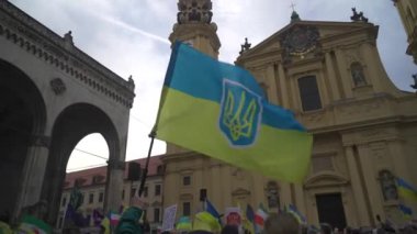 Munich. Germany. Odeonsplatz muenchen. Subject of war between Russia and Ukraine. Protesters holding yellow and blue and European Union flags at demonstration against war in Bayern. 