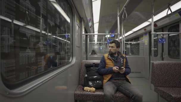 男子乘坐地铁在柏林 德国和使用智能手机 男人在通勤火车上有智能手机柏林地铁乘客通过电话上网 德国柏林U Bahn的Fahrgast — 图库视频影像
