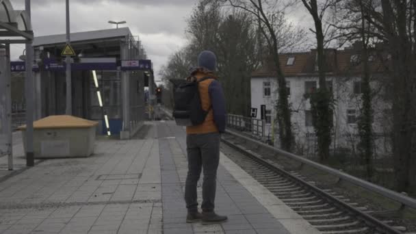 ドイツで列車のキャンセル ドイツのベルリンにある郊外鉄道駅で長期にわたる通勤列車を待っていた男 フォルト オースティン ドイツでは鉄道が遅れている 都市生活市民 — ストック動画