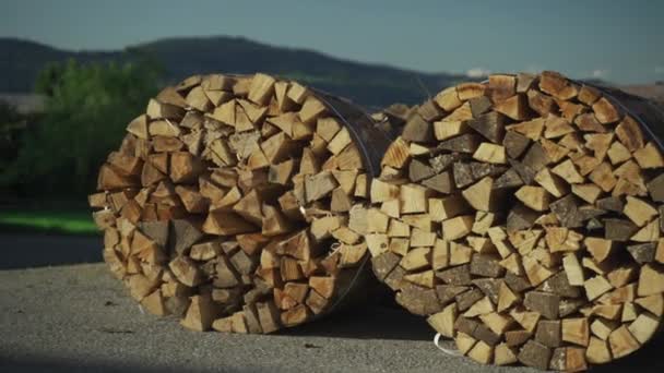 オーストリアの農場の丸いバレルに薪を収穫する バンドルされた薪 バイエルン ドイツ アルプスのワーキングハウスの背景に火の木を積みました 温室で木材を使用した暖房 — ストック動画