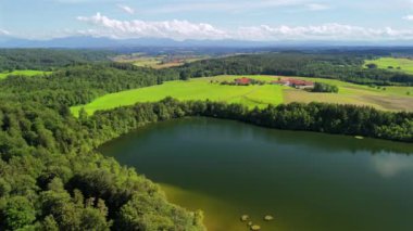 Steinsee bei Munchen Luftaufnahme. Steinsee, Bayern Luftbildansicht 'te. Almanya, Bavyera, Münih yakınlarındaki Stein Gölü hava manzarası. Almanya 'nın en sıcak göllerinden biri. Steinsee orman bölgesinde yer almaktadır.. 