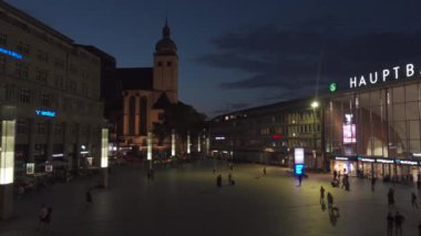 31 Temmuz 2024. Köln, Almanya. İnsanlar yazın geceleri Köln 'deki ana tren istasyonunun önündeki merdivenlerde dinleniyorlar. Koln Hauptbahnhof. Bahnhofsplatz Koeln Hbf Sommer 'de kalıyor.. 