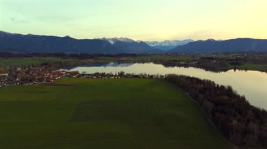 Oberbayern bei Sonnenuntergang 'dan Der Riegsee. Murnau, Bavyera, Almanya, Avrupa yakınlarındaki Riegsee Gölü 'nün havadan görüntüsü. Baharda gün batımında arka planda Ammergauer Alpen. Turizm Bölgesi Das Blaue Arazisi. 