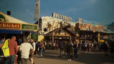 23 Eylül 2022. Münih. Almanya. Oktoberfest. 2022 'de güneşli bir havada Oktoberfest' teki lunapark. Oktoberfest 'teki insanlar. Münih 'te Ekim Festivali. Eğlence parkı mı? # İşte oldu #. 
