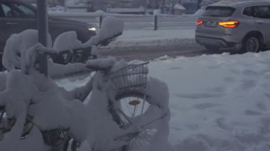 Münih, Almanya. Muenchen 'de kar yağışı. Şehrin otoparkında kar bisikletleri kapladı. Otoparkta kar yağışı ve bisikletler. Schneeeinbruch Münih, Deutschland. 
