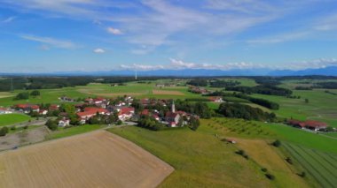 Pfarrkirche St. Michael, Bayern 'deki Alxing und Windfarm, Deutschland Luftaufnahme. Rüzgâr türbini köy kilisesinin hava manzarasının arkasında. Alxing Blick süper Pfarrkirche St. Michael auf Osterklinger Windrad. 