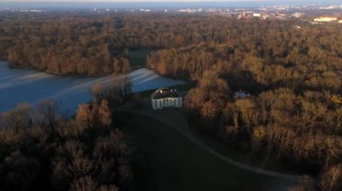 Badenburg Parkburg im Schlosspark Nymphenburg, Deutschland, Muenchen Luftaufnahme. Badenburg, Almanya 'nın Münih kentindeki Nymphenburg Palace Park' ta Badenburg Gölü 'nün güneydoğu ucunda yer almaktadır.. 