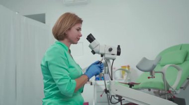 Gynecologist uses colposcope, optical device with magnification for detailed examination of cervix, vagina and vulva, helping to diagnose pathologies, detect precancerous changes. Women health. 