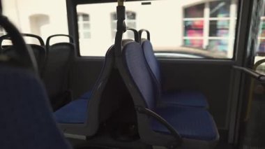 Münih, Almanya 'da bir halk otobüsünde boş mavi koltuklar. Modern şehir içi doğal gün ışığı, temiz ve ferah tasarım. Seyahat, ulaşım ya da seyahat kavramları için ideal