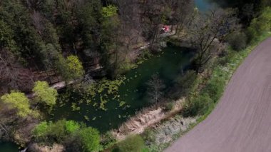 Luftaufnahme Spiegelweiher ve Almanya 'nın Bavyera kentindeki göletler, Grafing bei Munchen. Işıldayan gölleri, sakin yolları ve Güney Almanya 'da gelişen doğası olan manzaralı bahar manzarası.