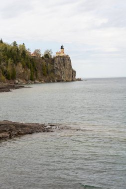 A beautiful view of Split Rock Lighthouse on the rocky coast of Lake Superior. A high-quality photo of water, lakes, rocks, trees, and plants taken in Duluth, North Shore, Lake Superior, Minnesota. clipart