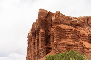 A cloudy and sunny view of red rocks at Capitol Reef National Park in Utah. A high-quality photo taken near Fruita, Utah. clipart