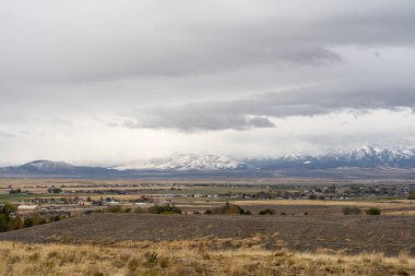 A stunning scenic view of the Stansbury Mountain range on a cloudy day taken from Bates Canyon Trailhead. A high-quality photo taken near Tooele, Utah. clipart