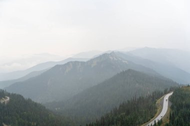 A stunning view of mountains on a rainy and cloudy day from atop Hurricane Ridge, Olympic National Park. A high-quality photo taken near Port Angeles, Washington. clipart