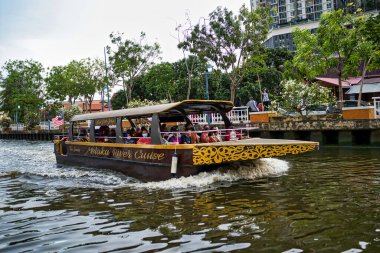 Melaka, Malaysia: March 5, 2022 - a river cruise boat cruising along the Melaka River. This has become a bog attraction