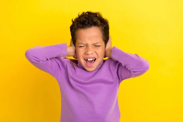 stock image Photo portrait of cute little boy closed eyes cover ears avoid noise ignore wear trendy violet look isolated on yellow color background.