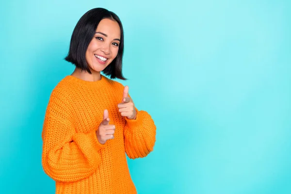 Photo of lovely confident girl with straight hairdo dressed orange pullover fingers pointing at you isolated on teal color background.