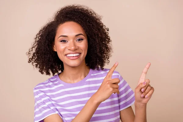 Closeup photo of young adorable pretty cute woman fingers directing empty space smile new offer isolated on beige color background.