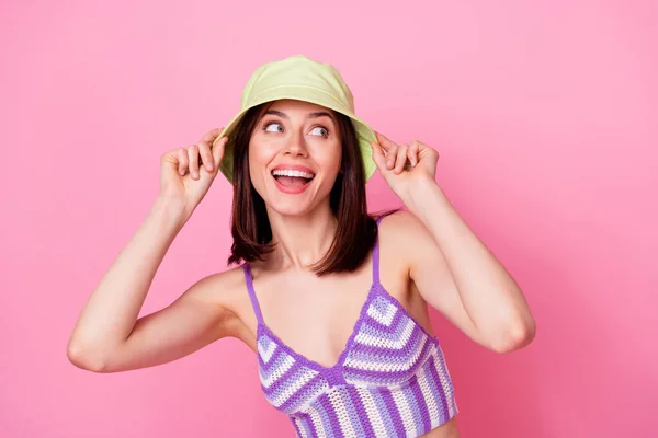 stock image Closeup photo of young shopaholic girl try on clothes headwear seems good look empty space isolated on pink color background.