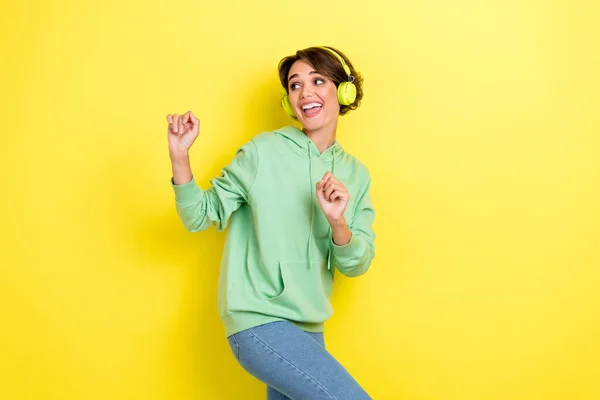 stock image Portrait of cheerful positive satisfied woman with bob hairdo green hoodie dancing look empty space isolated on yellow color background.