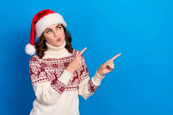 Photo of minded lady blow lips wear ugly jumper two arm direct empty space dilemma decision isolated on blue color background.