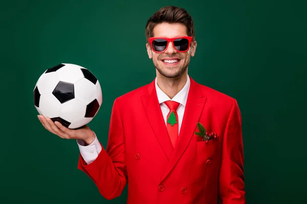 Photo of cheerful satisfied person hand hold demonstrate football isolated on green color background.