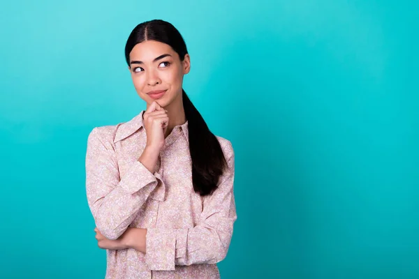 stock image Photo of creative minded thai person arm touch chin look interested empty space isolated on aquamarine color background.