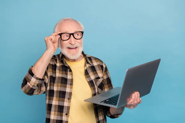 stock image Photo of funny pretty retired man wear plaid shirt spectacles writing modern device empty space isolated blue color background.