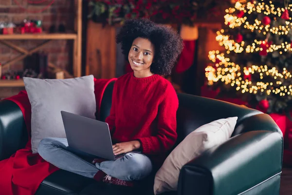 stock image Full length portrait of cheerful sweet girl sit couch use netbook enjoy x-mas spirit harmony house indoors.