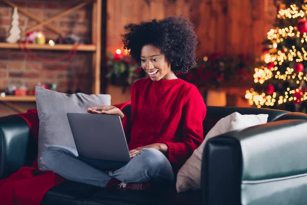 stock image Full size portrait of positive adorable kid girl sit couch speak communicate wireless netbook video call x-mas atmosphere house indoors.