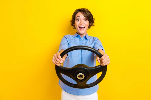 Photo of shocked funky lady wear blue shirt driving car screaming isolated yellow color background.